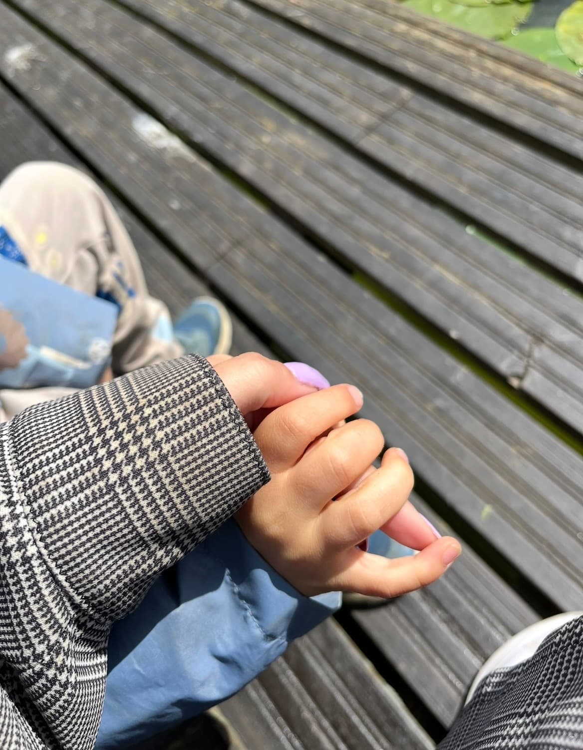 Hoitaja ja lapsi käsi kädessä — turvallinen ja lämmin arkihetki